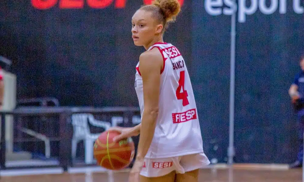 Bianca, usando o uniforme branco do Sesi Araraquara, controla a bola