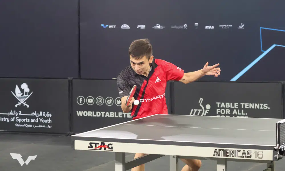 Vitor Ishiy, de vermelho, ataca bolinha com a raquete, no WTT Feeder de Dusseldorf