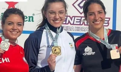 Geovana Meyer enquanto sorri no pódio da Copa Sul-Americana de tiro esportivo e Cibele Breide e Paula Yado