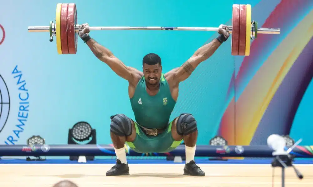 Marco Túlio Gregório carrega o halter com os pesos sobre sua cabeça. Ele competiu no Grand Prix de Havana em Cuba