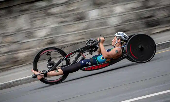 Na imagem, Jéssica Messali pedalando com sua bicicleta adaptada.