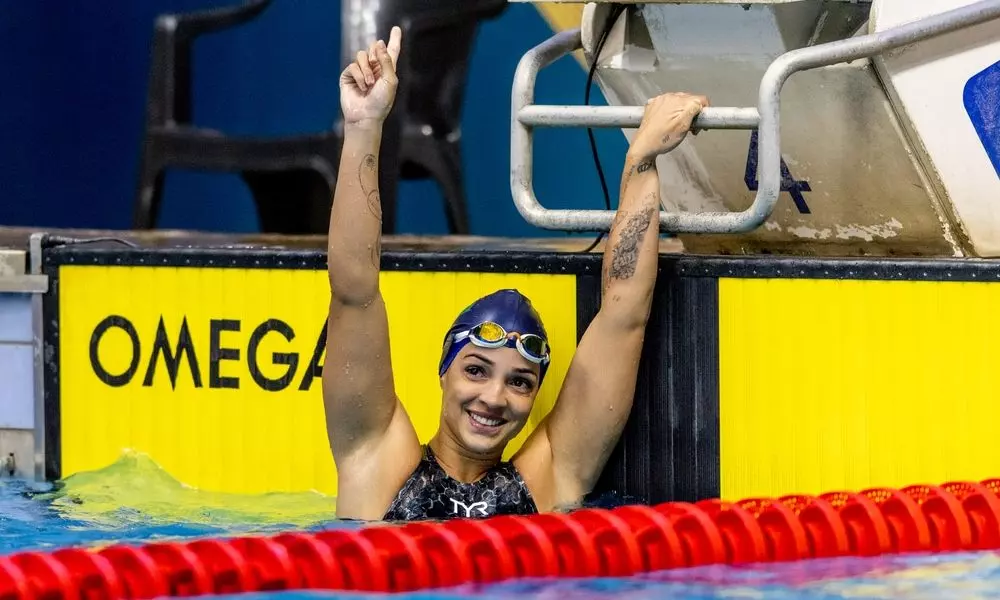 Jhennifer Alves Conceição ergue os braços e comemora vitória na natação; ela é destaque entre os atletas brasileiros em Chengdu-2021
