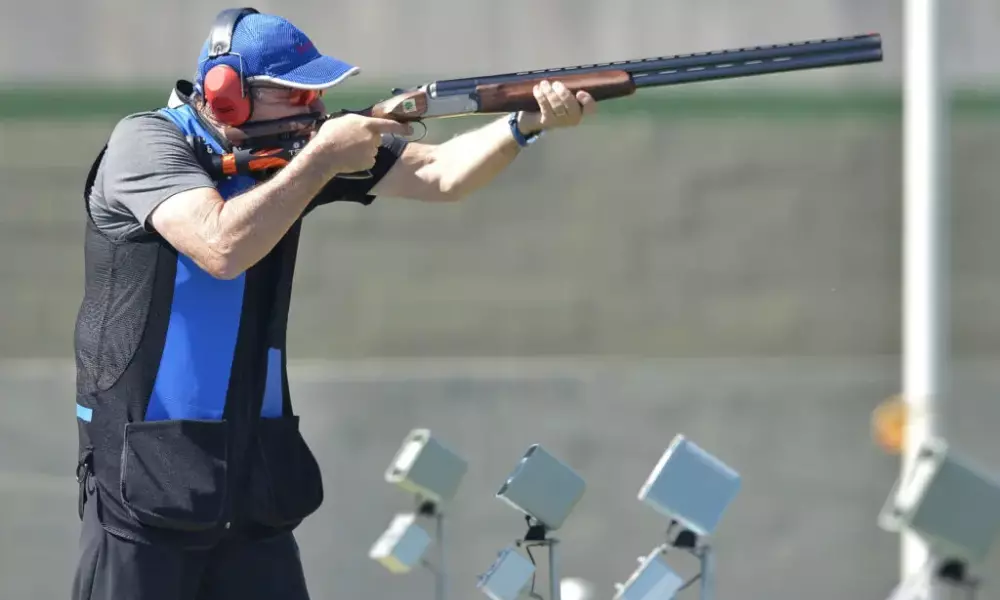 André Colin atirando com rifle em prova do tiro esportivo paralímpico