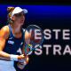 Bia Haddad, de camiseta azul e saia e boné branco, com a raquete na mão em frente a um backdrop escrito "Western Australia"; ela está na semifinal do WTA 500 de Adelaide, ao lado de Taylor Townsend