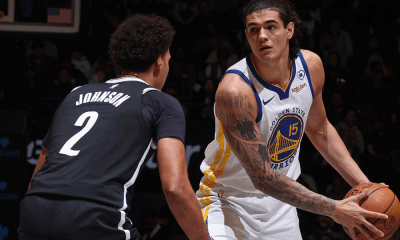 Gui Santos, do Golden State Warriors, segura bola enquanto é marcado por jogador do Brooklyn Nets na NBA. Ele recebeu elogios de Steve Kerr