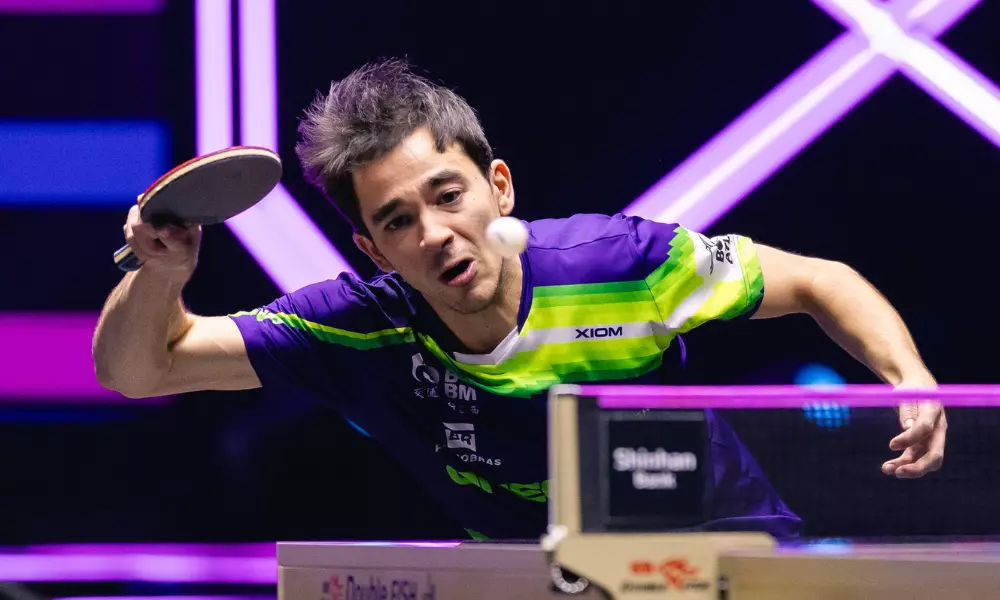 Hugo Calderano em ação, fazendo careta perto da mesa, no WTT Champions Incheon