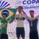 Na imagem, Ulan Galinski no pódio, com a bandeira do Brasil.